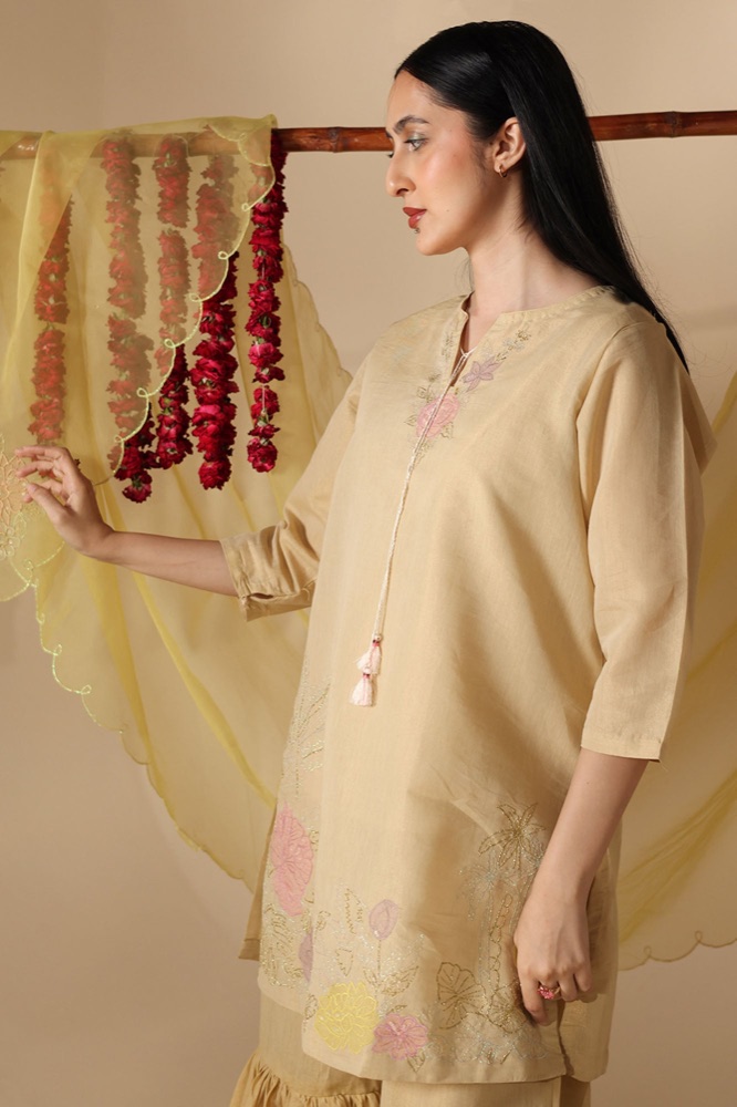 Honey peach embroidered gharara ensemble with a matching net dupatta